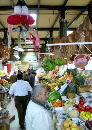 Fresh fruit stalls and a hanging piñata