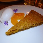 A tart with honey, rosemary and pine nuts accompanied with an oro blanco sorbet and citrus segments from Bestia in downtown Los Angeles