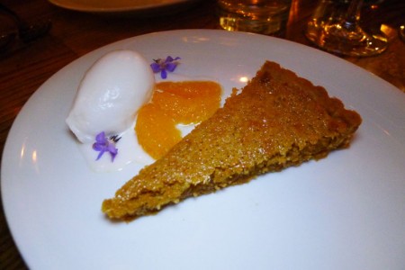 A tart with honey, rosemary and pine nuts accompanied with an oro blanco sorbet and citrus segments from Bestia in downtown Los Angeles