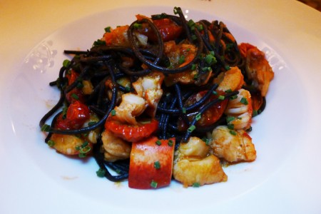 Black squid ink spaghetti made with lobster and tomato is served at Sirio Ristorante
