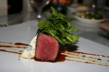 Coffee-crusted New York strip with Fourme d’Ambert blue cheese, wild arugula and a Bourbon-caramel sauce, a signature dish at The Loft