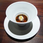 Custard with grilled cepes and black truffle consommé is served at Saison in San Francisco, CA.