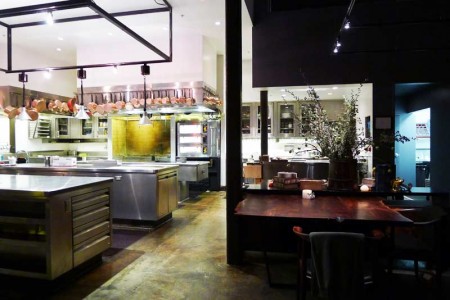 Open kitchen flows into the dining area of Saison restaurant in San Francisco, CA.